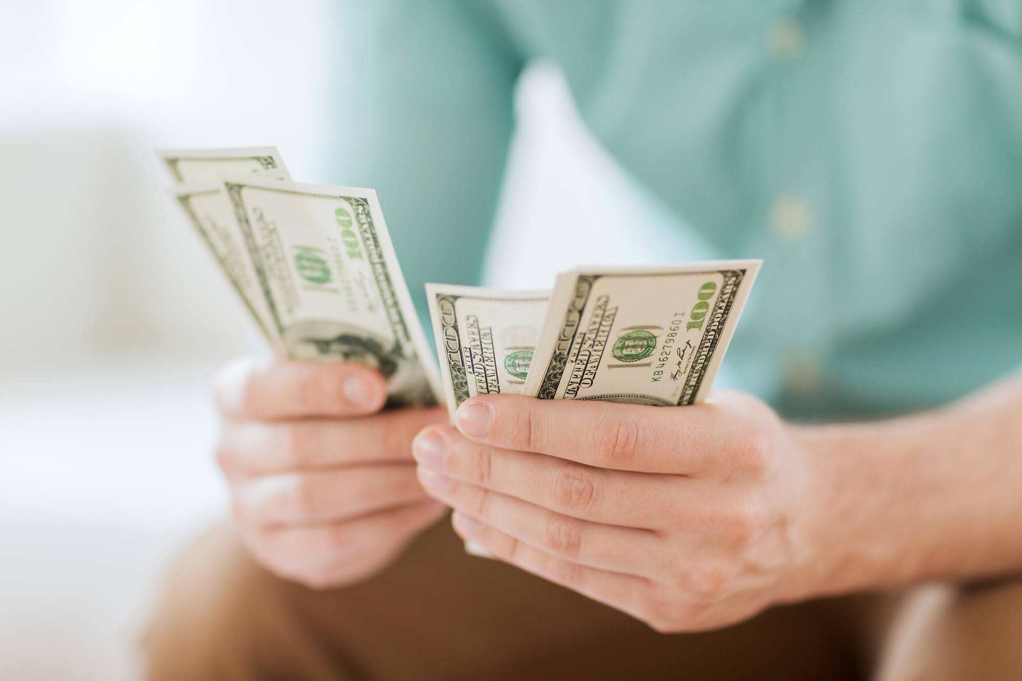 Counting hundred dollar bills