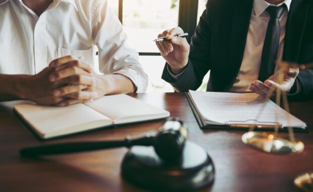 Professional bail bonds agent assisting family with confidential paperwork.