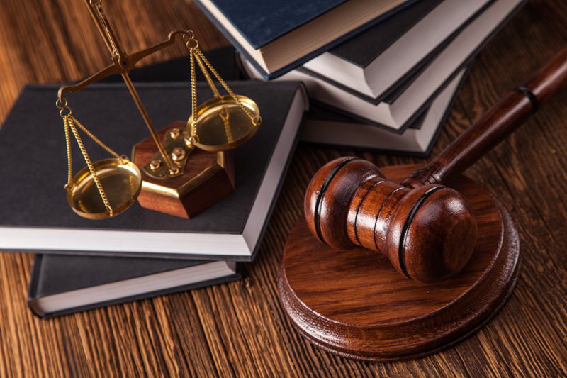 Gavel and scales on legal books
