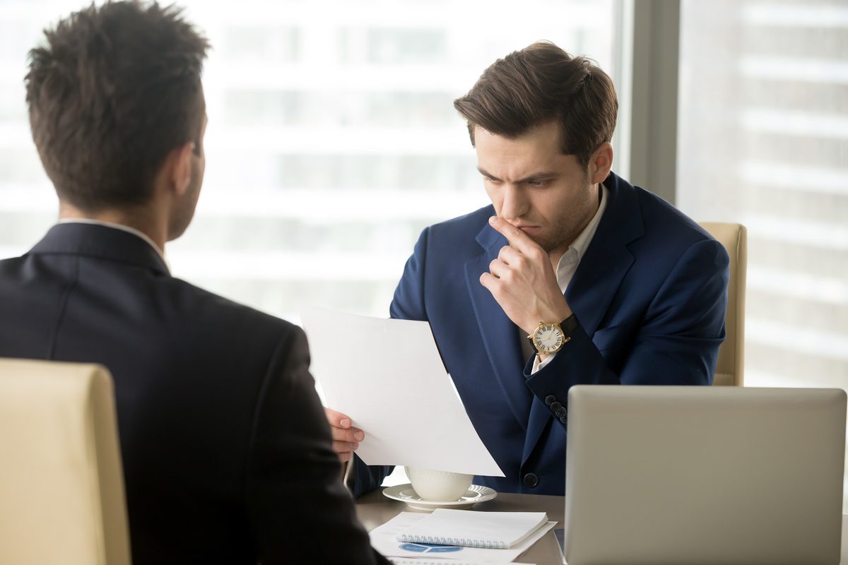 Worried client reviewing bail bond paperwork with an agent