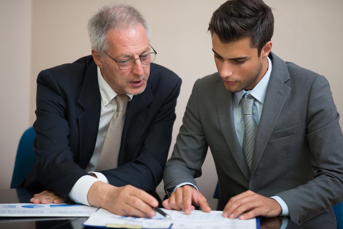 Bail bond agent and client reviewing payment documents together