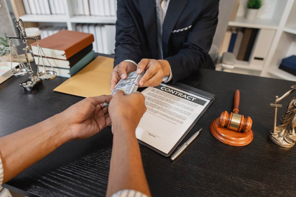 Client handing over a payment card while signing a bail bond contract