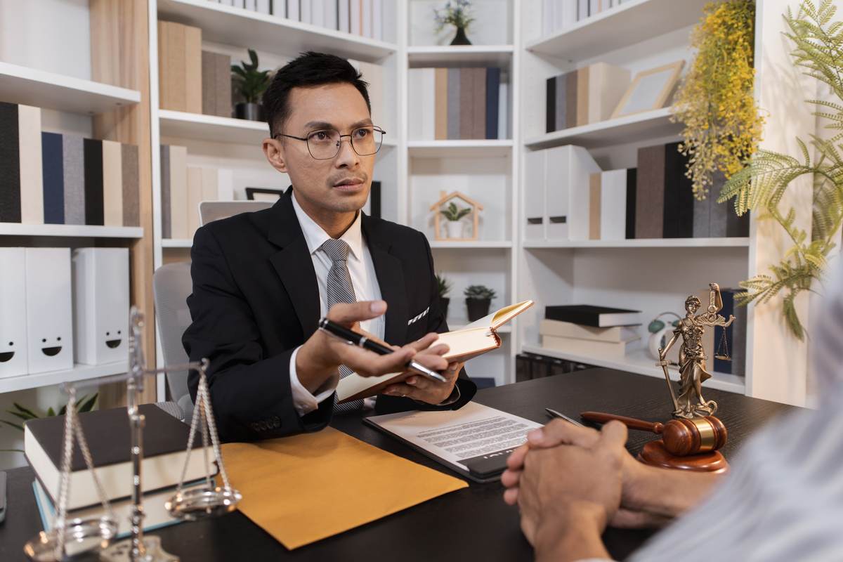 Bail bond agent discussing payment options with a client at his desk